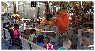 Teacher Teaching Children About Pumpkins